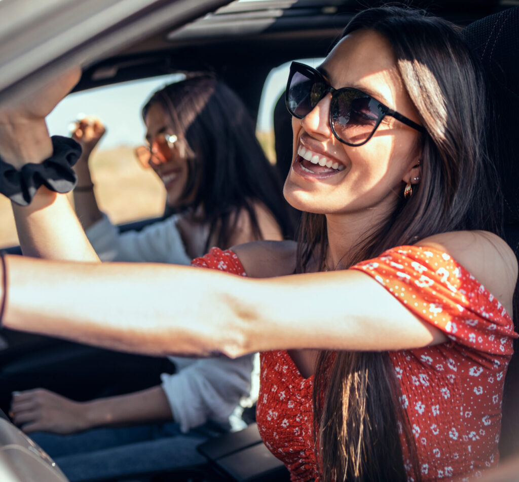 Happy friends in car